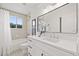 Bright bathroom with a white vanity, modern fixtures, and a shower-tub combo at 18307 White Fang Ct, Parrish, FL 34219