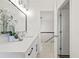 Modern bathroom features a white vanity with stone countertop and contemporary lighting at 18307 White Fang Ct, Parrish, FL 34219