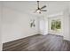 Bright bedroom showcasing sleek wood-look flooring and large windows with outdoor views at 18307 White Fang Ct, Parrish, FL 34219