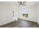 Bright bedroom showcasing an arched window with nice views and sleek wood-look flooring at 18307 White Fang Ct, Parrish, FL 34219