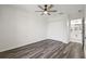 Bright bedroom features sleek wood-look floors, ceiling fan and a double door closet at 18307 White Fang Ct, Parrish, FL 34219