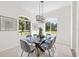 Bright dining room with a glass table, comfortable seating, and picturesque outdoor views at 18307 White Fang Ct, Parrish, FL 34219
