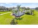 Expansive view of the side and rear of this luxurious home, featuring a covered screened in pool and lush landscaping at 18307 White Fang Ct, Parrish, FL 34219