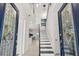 Bright foyer with a staircase, stylish lighting fixtures, and an open view into the living spaces at 18307 White Fang Ct, Parrish, FL 34219
