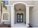 Elegant front entrance showcasing a double door with decorative glass and white pillars at 18307 White Fang Ct, Parrish, FL 34219