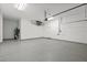 Spacious garage features a speckled floor, utility sink, and access door to the house at 18307 White Fang Ct, Parrish, FL 34219