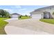 A long driveway leads to the home's garage and a detached garage on an expansive, well-manicured lawn at 18307 White Fang Ct, Parrish, FL 34219