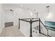 Hallway with tile flooring and staircase with white and black railings at 18307 White Fang Ct, Parrish, FL 34219