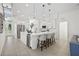 Modern kitchen featuring a central island with seating, wine cooler, and stainless steel appliances at 18307 White Fang Ct, Parrish, FL 34219