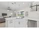 Stylish kitchen with an island, quartz countertops, stainless steel appliances, and an open view to the pool at 18307 White Fang Ct, Parrish, FL 34219