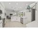 Open kitchen featuring a large island, modern appliances, and an airy design with access to the living area at 18307 White Fang Ct, Parrish, FL 34219