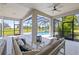 Relaxing lanai featuring comfortable seating with a view of the sparkling pool and lush backyard at 18307 White Fang Ct, Parrish, FL 34219