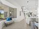 Open floor plan with a modern kitchen, staircase, and living area featuring bright natural light and neutral tones at 18307 White Fang Ct, Parrish, FL 34219