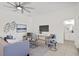 Cozy living room with stylish decor, a flat-screen TV, and access to a modern bathroom and seating area at 18307 White Fang Ct, Parrish, FL 34219