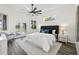 Cozy main bedroom with a ceiling fan and double doors leading to the pool area at 18307 White Fang Ct, Parrish, FL 34219