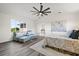 Bright bedroom with large window, ceiling fan, and decorative artwork at 18307 White Fang Ct, Parrish, FL 34219