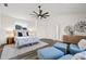 A sunlit main bedroom featuring a ceiling fan and decorative artwork at 18307 White Fang Ct, Parrish, FL 34219