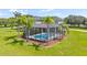 A beautiful screened-in pool area with palms provides a tranquil outdoor space to relax and enjoy the beautiful weather at 18307 White Fang Ct, Parrish, FL 34219