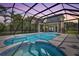 Large screened-in pool with spa, sun-drenched deck, and an amazing view of the backyard at sunset at 18307 White Fang Ct, Parrish, FL 34219