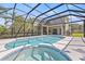 Relaxing screened-in pool with spa, sun-drenched deck, and expansive view of the backyard at 18307 White Fang Ct, Parrish, FL 34219