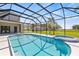 Backyard oasis featuring a screened-in pool, sun-drenched deck, integrated spa, and expansive views at 18307 White Fang Ct, Parrish, FL 34219