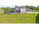 View of the pool and back of the house with lush green yard; the perfect outdoor oasis for relaxation and fun at 18307 White Fang Ct, Parrish, FL 34219