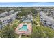 Aerial view of community featuring a pool, green spaces, and well-maintained landscaping at 1850 Sunny Dr # F4, Bradenton, FL 34207