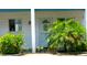 Inviting front door entrance with colorful landscaping and a welcoming aesthetic at 1850 Sunny Dr # F4, Bradenton, FL 34207