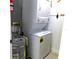 Convenient laundry room with stackable washer and dryer, and hot water heater at 1850 Sunny Dr # F4, Bradenton, FL 34207