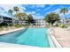 Large in-ground pool surrounded by lounge chairs and lush landscaping at 1850 Sunny Dr # F4, Bradenton, FL 34207
