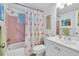 Bathroom with pink tile, flamingo shower curtain, and sink with vanity at 2014 Canal Dr # M6, Bradenton, FL 34207