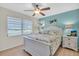 Cozy bedroom featuring a queen-size bed, natural light from a window, and comfortable furnishings at 2014 Canal Dr # M6, Bradenton, FL 34207