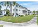Exterior view of condo building with well-maintained landscaping and sidewalk at 2014 Canal Dr # M6, Bradenton, FL 34207