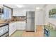 Cozy kitchen featuring stainless steel refrigerator and white cabinets at 2014 Canal Dr # M6, Bradenton, FL 34207