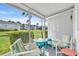 Screened-in lanai featuring comfortable outdoor seating, and views of tropical landscaping at 2014 Canal Dr # M6, Bradenton, FL 34207