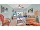 Comfortable living room with ceiling fan, neutral tones, and sliding glass door leading to outdoor space at 2014 Canal Dr # M6, Bradenton, FL 34207