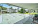 Outdoor shuffleboard courts under a covered area surrounded by tropical landscaping and white condo buildings at 2014 Canal Dr # M6, Bradenton, FL 34207
