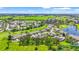 Expansive aerial view captures a charming community near a golf course and sparkling lake at 2417 Fairway Oaks Dr # 22, Palmetto, FL 34221