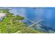 High-angle shot of the building with water views, lush landscaping, and the pier at 2417 Fairway Oaks Dr # 22, Palmetto, FL 34221