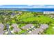 Wide aerial view of a golf community featuring tropical landscaping and multiple water features at 2417 Fairway Oaks Dr # 22, Palmetto, FL 34221