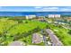 Scenic aerial view of waterfront condos with lush green spaces and trees in a golf course community at 2417 Fairway Oaks Dr # 22, Palmetto, FL 34221