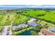 Aerial showcasing the tennis and shuffleboard courts, surrounded by lush green golf course at 2417 Fairway Oaks Dr # 22, Palmetto, FL 34221