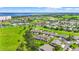 Expansive aerial view of a golf course community with lush green fairways and water views at 2417 Fairway Oaks Dr # 22, Palmetto, FL 34221