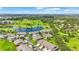Aerial view of homes surrounding a scenic pond and golf course, highlighting community amenities at 2417 Fairway Oaks Dr # 22, Palmetto, FL 34221