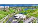 Aerial shot of clubhouse, pool, and golf course with pristine landscaping and serene water views at 2417 Fairway Oaks Dr # 22, Palmetto, FL 34221