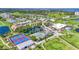 Aerial view of a golf course community with tennis courts and manicured landscaping at 2417 Fairway Oaks Dr # 22, Palmetto, FL 34221