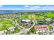 Aerial view of the community clubhouse, golf course, and picturesque waterfront at 2417 Fairway Oaks Dr # 22, Palmetto, FL 34221