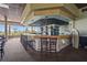 Well-stocked bar with seating, wooden accents, and a view of the golf course through the windows at 2417 Fairway Oaks Dr # 22, Palmetto, FL 34221