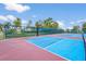 Outdoor basketball court and tennis courts with well maintained surface and netting with landscaping at 2417 Fairway Oaks Dr # 22, Palmetto, FL 34221