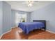 This bedroom has wood-look floors and a window with curtains at 2417 Fairway Oaks Dr # 22, Palmetto, FL 34221